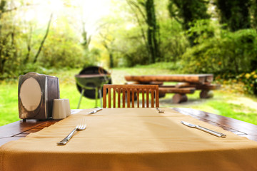 Desk of free space and grill background in garden. 