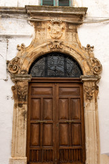 Italy, Ostuni, gate of an ancient building in the historic center