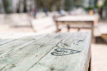 ink heart on a wooden table in picnic area