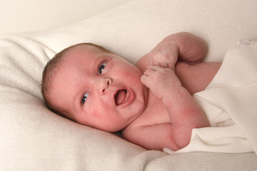 Cute little baby on bed at home