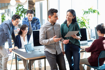 Young abroad students talking in computer lab