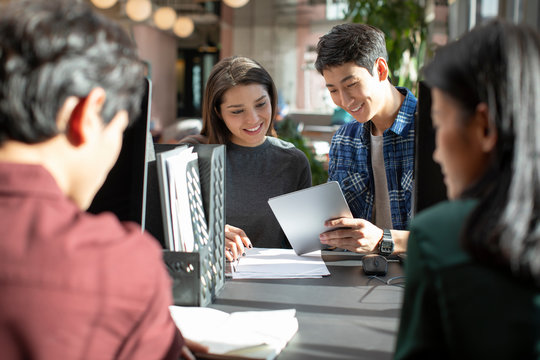 Young abroad students talking in computer lab