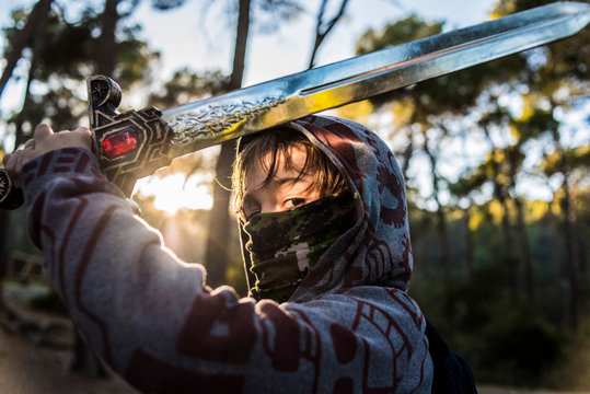 Child dressed as a warrior playing with his sword