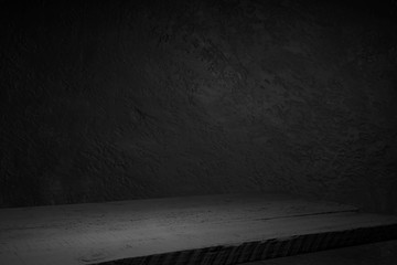 cement floor in dark room with spot light. black background.