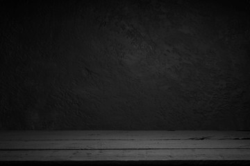 cement floor in dark room with spot light. black background.