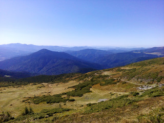 Mountain landscape green hills against the blue sky.