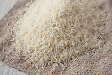 Dry white rice basmati on cloth, side view. Closeup.