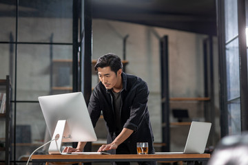 Photographer using computer in studio