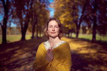 Pretty woman portrait in autumn park