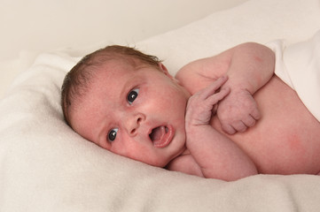 Cute little baby on bed at home