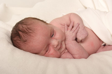 Cute little baby on bed at home