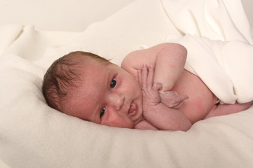 Cute little baby on bed at home