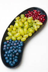 Platter with fresh fruit on white tablecloth