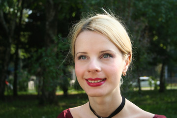 Beautiful European blonde girl in summer in the Park, close-up