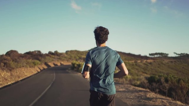 Male runner running on road