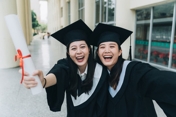 successful happy graduates making selfie photo