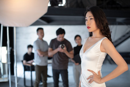 Photographer taking picture of model in studio