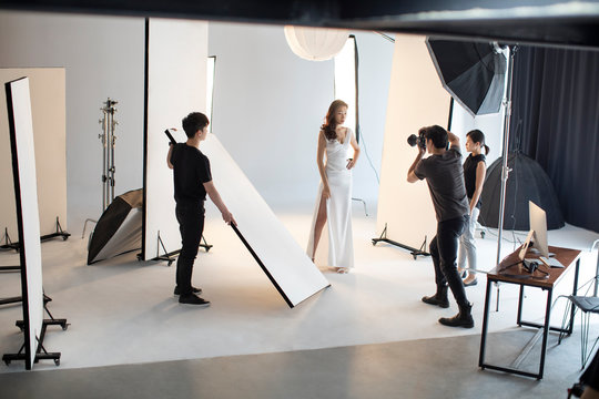 Photographer taking picture of model in studio