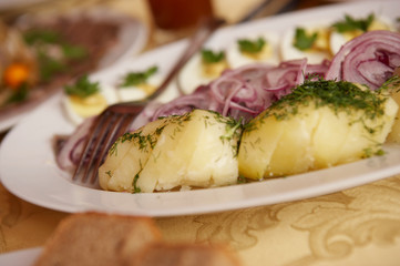 PLATE OF MARINATED HERRING WITH EGG AND POTATO IN MOSCOW RESTAURANT