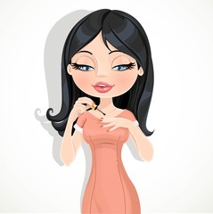 Beautiful brunette girl in a red dress paints her nails isolated on white background