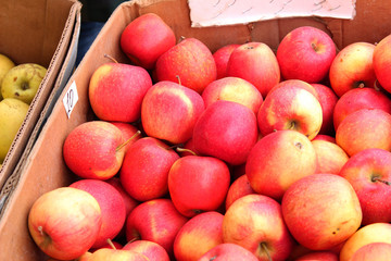 Fresh fruit in boxes. Market on the street. Red  apples. 