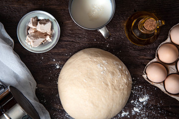Raw dough and ingridients, food flat lay on kitchen table background