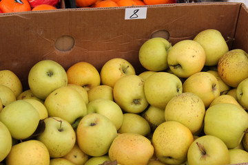 Fresh fruit in boxes. Market on the street. Green apples. 