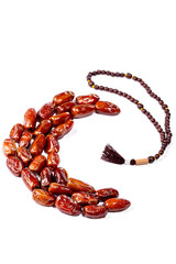 Dried dates laid out in the shape of a Crescent on a white background. The concept of the Holy Muslim month of Ramadan Karim