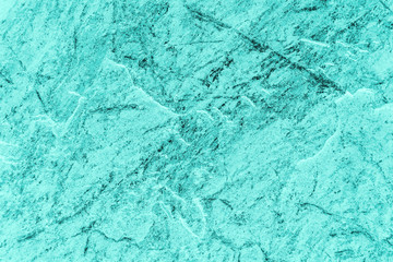 Vintage azure background. Rough painted wall of turquoise color. Imperfect plane of cyan colored. Uneven old decorative toned backdrop of aqzure tint. Texture of teal hue. Ornamental stony surface.