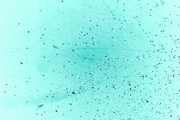 Vintage azure background. Rough painted wall of turquoise color. Imperfect plane of cyan colored. Uneven old decorative toned backdrop of aqzure tint. Texture of teal hue. Ornamental stony surface.