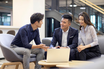 Confident business people talking in office