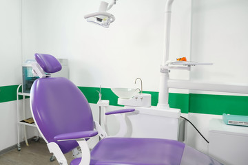 Dental chair and other accessories used by dentists in dental office. Modern dental practice.