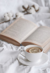 mug of hot tea and book