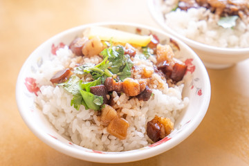 Braised pork over rice - Taiwan famous traditional street food delicacy. Soy-stewed pork on rice. Travel design concept. Top view,copy space,close up
