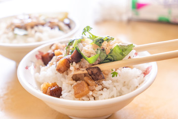 Braised pork over rice - Taiwan famous traditional street food delicacy. Soy-stewed pork on rice. Travel design concept. Top view,copy space,close up