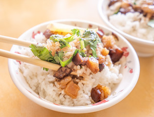 Braised pork over rice - Taiwan famous traditional street food delicacy. Soy-stewed pork on rice. Travel design concept. Top view,copy space,close up