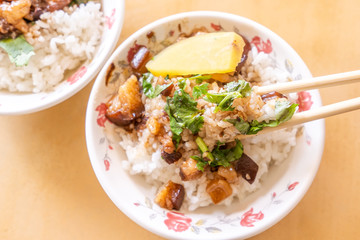 Braised pork over rice - Taiwan famous traditional street food delicacy. Soy-stewed pork on rice. Travel design concept. Top view,copy space,close up