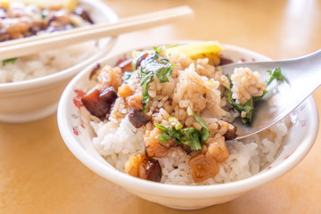 Braised pork over rice - Taiwan famous traditional street food delicacy. Soy-stewed pork on rice. Travel design concept. Top view,copy space,close up