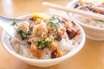 Braised pork over rice - Taiwan famous traditional street food delicacy. Soy-stewed pork on rice. Travel design concept. Top view,copy space,close up