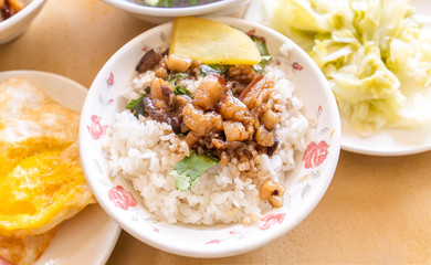 Braised pork over rice - Taiwan famous traditional street food delicacy. Soy-stewed pork on rice. Travel design concept. Top view,copy space,close up