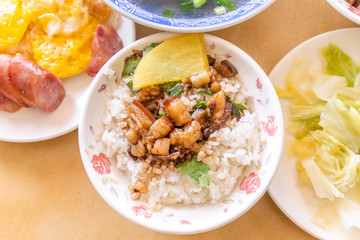 Braised pork over rice - Taiwan famous traditional street food delicacy. Soy-stewed pork on rice. Travel design concept. Top view,copy space,close up