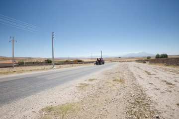 Tractor rides on the road