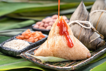 Zongzi, steamed rice dumplings with chili sauce. Close up, copy space, famous asian tasty food in dragon boat duanwu festival