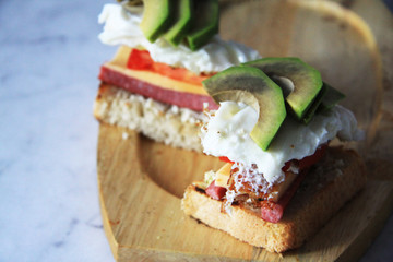 Cold cut sausage on wheat with Swiss cheese, tomato, egg and avocado