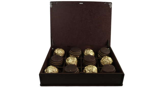 Chocolate ball with almond Box in a gold foil paper with White Background