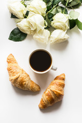 Cup of coffee and freshly baked croissants. Top view. Copy space.