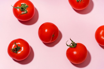 Pattern with cherry tomatoes on pink background