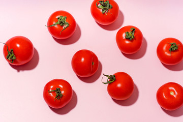 Pattern with cherry tomatoes on pink background