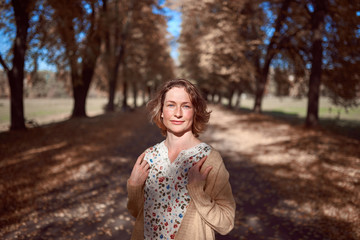 Pretty woman portrait in autumn park