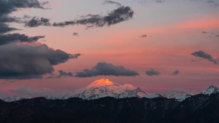 sunset sun illuminates the top of Mount Elbrus, timelapse 4K
